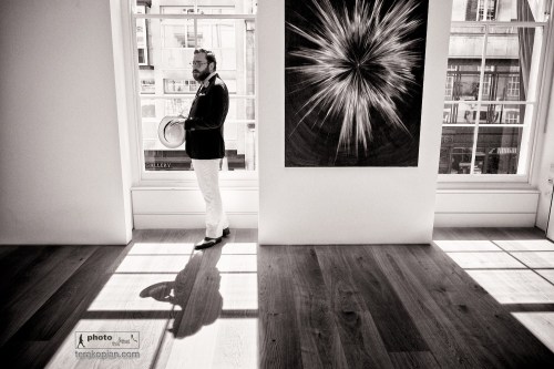 The Summer Saunter. A group of bold and independent men led by stylist Timothy Lord and The Chap Magazine’s Albion step out in style in the name of sartorial freedom, from the steps of St. Paul’s Cathedral to Mayfair’s Berkeley Square in a demonstration of solidarity with all men who dare to dress differently. London, UK. Toby Pennington at an exhibition by Agnieszka Brzeżańska, Marlborough Contemporary gallery, Albemarle Street, London, where the gentlemen stopped for a Champagne break. July 21, 2013. Photo: Edmond Terakopian  July 21, 2013. Photo: ©Edmond Terakopian