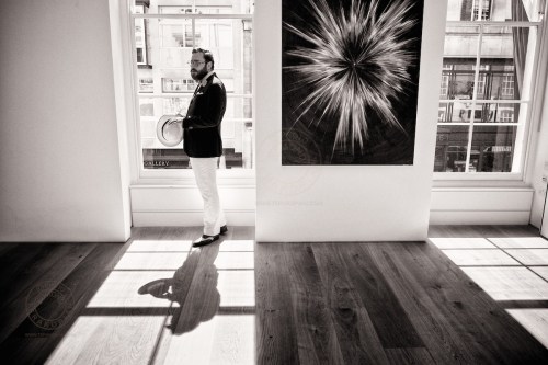 The Summer Saunter. A group of bold and independent men led by stylist Timothy Lord and The Chap Magazine’s Albion step out in style in the name of sartorial freedom, from the steps of St. Paul’s Cathedral to Mayfair’s Berkeley Square in a demonstration of solidarity with all men who dare to dress differently. London, UK. Toby Pennington at an exhibition by Agnieszka Brzeżańska, Marlborough Contemporary gallery, Albemarle Street, London, where the gentlemen stopped for a Champagne break. July 21, 2013. Photo: Edmond Terakopian  July 21, 2013. Photo: Edmond Terakopian