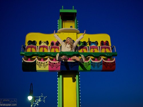 Andrea Feczko (American TV Presenter and digital content creator. www.andreafeczko.com), at the funfair on Santa Monica pier in the evening. LA, USA. January 14, 2014. Photo: Edmond Terakopian